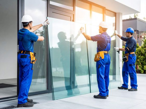 Installer fitting a frameless glass panel