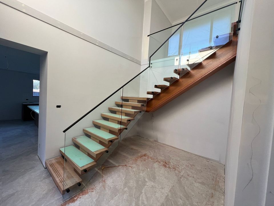 Glass stair balustrade with matte black handrail